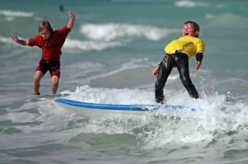 United Arab Emirates - Dubai - February 5, 2011.

NATIONAL: James Cargill (cq-al), 7, left, and Alexander Needham (cq-al), 10, right, both of Dubai, compete in the "gromments" (cq-al) division of the Surf Dubai Sunset Open 2011 in Dubai on Saturday, February 5, 2011. "It's good fun," said Cargill who has been surfing for 18 months. Amy Leang/The National