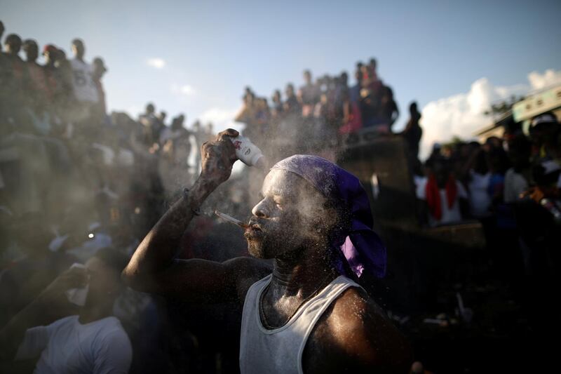 A Voodoo believer covers his face with baby powder at a cemetery in Port-au-Prince, Haiti. Reuters