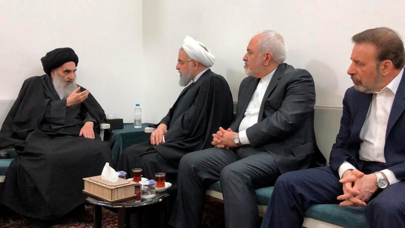 In this handout photo from the office of Grand Ayatollah Ali al-Sistani, Iranian President Hassan Rouhani, second left, meets with Iraq's most senior Shiite cleric Grand Ayatollah Ali al-Sistani, left, accompanied by Iranian Foreign Minister Mohammad Javad Zarif, second right, in the southern Iraqi city of Najaf, Wednesday, March, 13, 2019. Al-Sistani rarely meets officials and Rouhani is likely to score points at home over the meeting. (Office of Grand Ayatollah Ali al-Sistani, via AP)