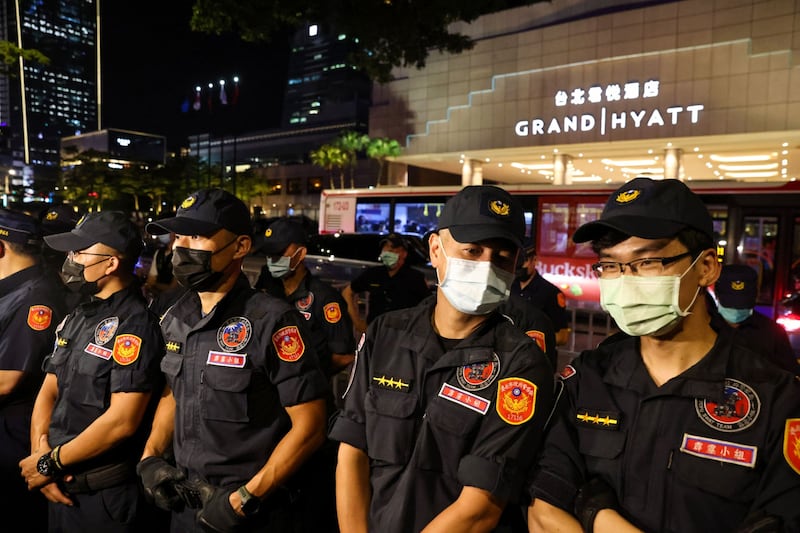 Police officers stand outside the Grand Hyatt Taipei. Bloomberg