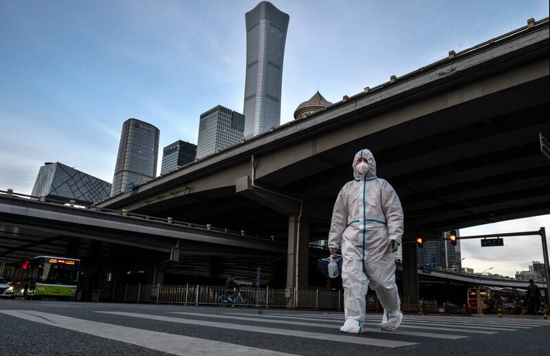 An epidemic control worker in central Beijing, where the number of coronavirus cases is mounting. Getty Images