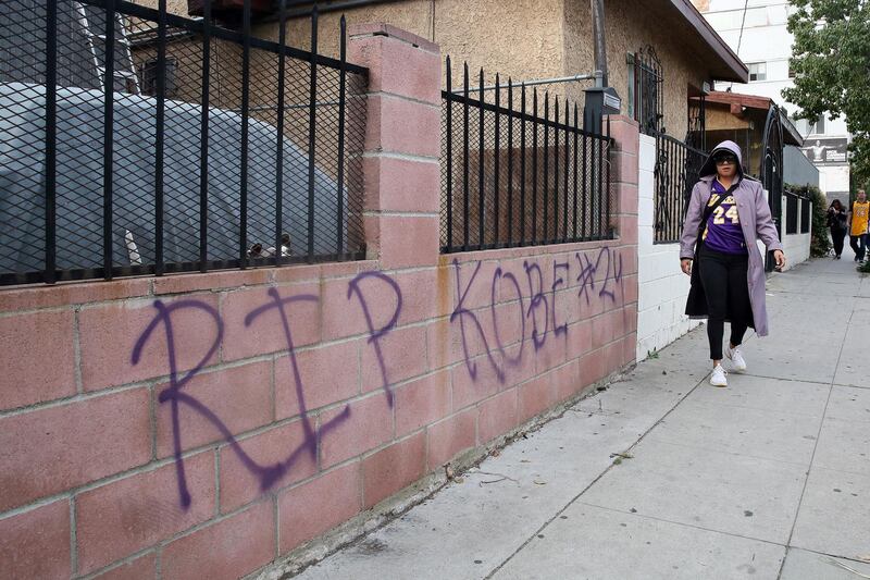 A fan writes a message in front of their house in memory of former Los Angeles Lakers guard Kobe Bryant in Los Angeles, California.  EPA