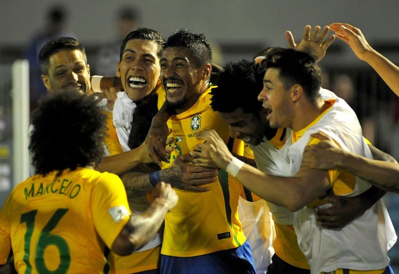 Midfielder Paulinho, centre, is enjoying a return to form as a Brazil international. Dante Fernandez / AFP