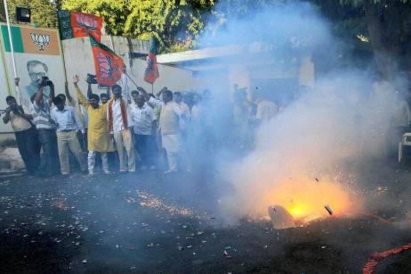 Hindu nationalist Bharatiya Janata Party workers celebrate with fire crackers after Ayodhya verdict in New Delhi,  India, Thursday, Sept. 30, 2010. An Indian court ruled Thursday that a disputed holy site that has sparked bloody communal riots across the country in the past should be divided between the Hindu and Muslim communities.However, the court gave the Hindu community control over the section where the now demolished Babri Mosque stood and where a small makeshift tent-shrine to the Hindu god Rama rests. While both Muslim and Hindu lawyers vowed to appeal to the Supreme Court, the compromise ruling seemed unlikely to set off a new round of violence, as the government had feared.(AP Photo)**INDIA OUT**