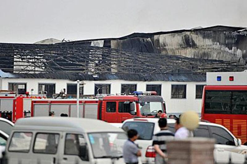 Rescue workers and fire trucks are seen outside a site of a fire, at a poultry slaughterhouse in Dehui, Jilin province. Reuters/Xinhua/Wang Haofei