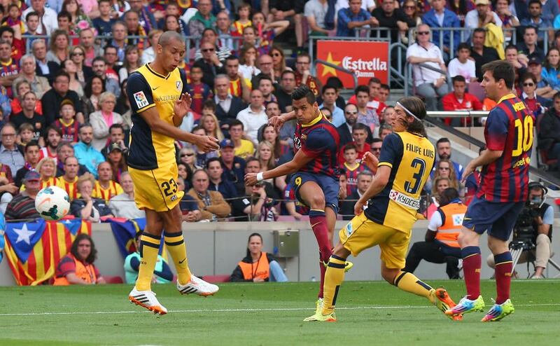 Alexis Sanchez of FC Barcelona scores the opening goal during against Atletico Madrid on Saturday. Alex Livesey / Getty Images / May 17, 2014