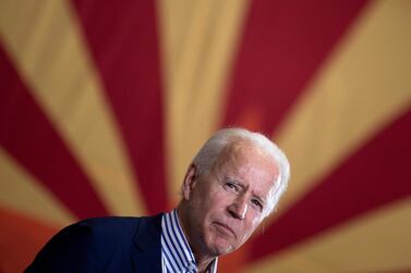 US president-elect Joe Biden speaks to supporters in front of an Arizona state flag during a campaign stop in Phoenix on October 8, 2020. AFP