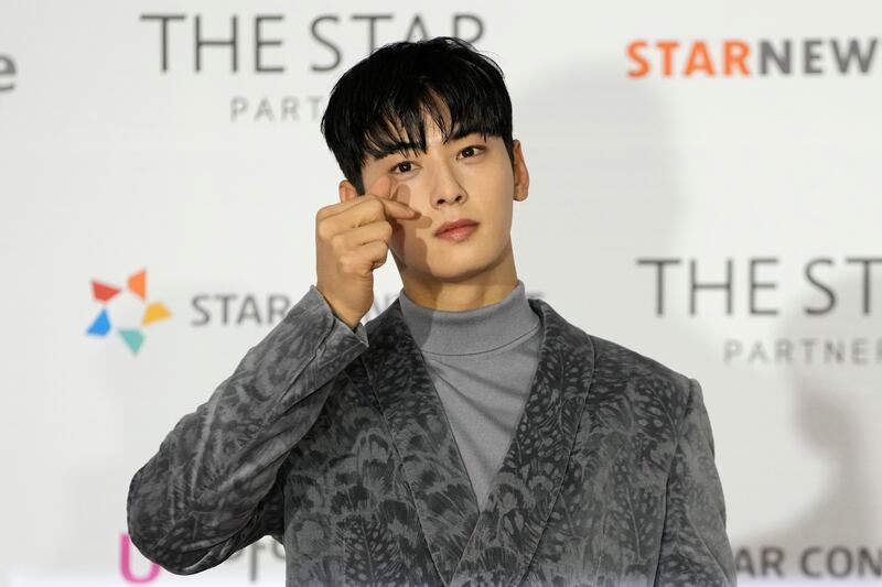 Cha Eun-woo, a member of the band, poses for photos on the red carpet for the 2021 Asia Artist Awards. AP Photo