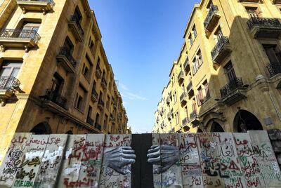 This picture taken on January 28, 2020 shows a view of a graffiti-covered concrete barrier erected by Lebanese security forces separating Riad al-Solh square from the parliament headquarters in the capital Beirut's central downtown district. (Photo by JOSEPH EID / AFP)