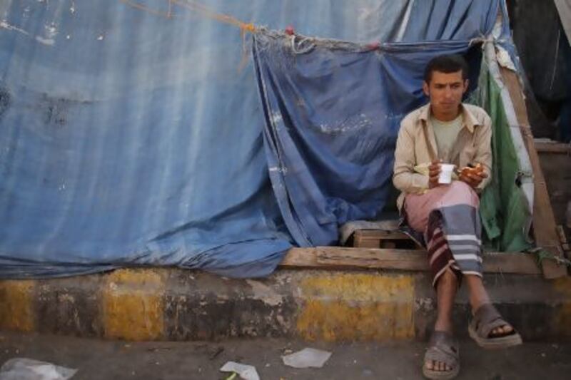 A protester sits outside his makeshift hut at a pro-democracy protest camp in Sanaa, Yemen.