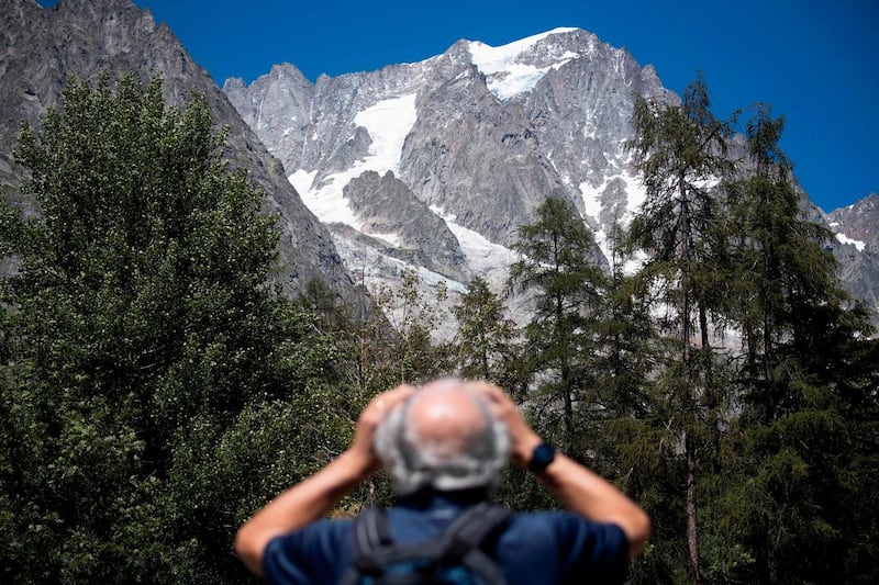 A man looks up to the Planpincieux glacier from the village of La Palud, in Courmayeur, Val Ferret, northwestern Italy. AFP