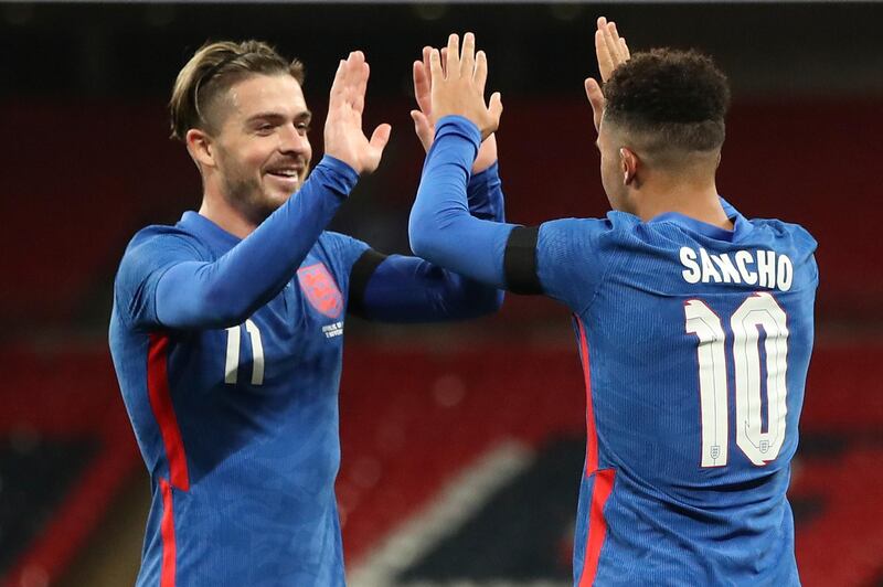 England's Jadon Sancho, right, celebrates with Jack Grealish after scoring this side's 2nd goal during the international friendly soccer match between England and Ireland at Wembley stadium in London, England, Thursday Oct. 12, 2020. (Nick Potts/Pool via AP)