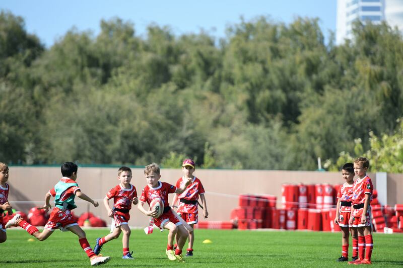 Young boys practice on the field at Dubai Police Academy, Dubai. 