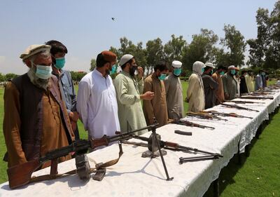 FILE PHOTO: Members of the Taliban handover their weapons and join in the Afghan government's reconciliation and reintegration program in Jalalabad, Afghanistan June 25, 2020. REUTERS/Parwiz/File Photo