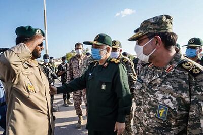 This handout photo provided by Iran's Revolutionary Guard Corps (IRGC) official website via SEPAH News on January 2, 2021, shows Guards' chief Major General Hossein Salami (C), accompanied by Islamic Revolutionary Guard Corps navy commander Rear Admiral Alireza Tangsiri (R), inspecting troops during his visit to the island of Abu Musa, off the coast of the southern Iranian city of Bandar Lengeh facing the United Arab Emirates.  Salami vowed today to respond to any "action the enemy takes" in a visit to the strategic island in the Gulf, amid rising tensions with the US,  speaking on the eve of the first anniversary of the US killing of top Iranian military commander Qasem Soleimani in a Baghdad drone strike on January 3, 2020 - XGTY / RESTRICTED TO EDITORIAL USE - MANDATORY CREDIT "AFP PHOTO / Iran's Revolutionary Guard via SEPAH NEWS" - NO MARKETING - NO ADVERTISING CAMPAIGNS - DISTRIBUTED AS A SERVICE TO CLIENTS

 / AFP / SEPAH NEWS / - / XGTY / RESTRICTED TO EDITORIAL USE - MANDATORY CREDIT "AFP PHOTO / Iran's Revolutionary Guard via SEPAH NEWS" - NO MARKETING - NO ADVERTISING CAMPAIGNS - DISTRIBUTED AS A SERVICE TO CLIENTS

