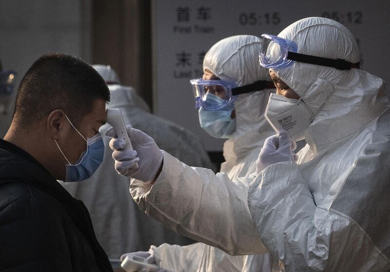 BEIJING, CHINA - JANUARY 25: A Chinese health worker checks the temperature of a woman entering a subway station during the Chinese New Year and Spring Festival on January 25, 2020 in Beijing, China. The number of cases of a deadly new coronavirus rose to over 1300 in mainland China Saturday as health officials locked down the city of Wuhan earlier in the week in an effort to contain the spread of the pneumonia-like disease which medicals experts have been confirmed can be passed from human to human. In an unprecedented move, Chinese authorities put travel restrictions on the city of Wuhan and neighbouring cities affecting a population of over 35 million. The number of those who have died from the virus in China climbed to at least 41 on Saturday and cases have been reported in other countries including the United States, Australia, France, Thailand, Japan, Taiwan and South Korea. (Photo by Kevin Frayer/Getty Images)