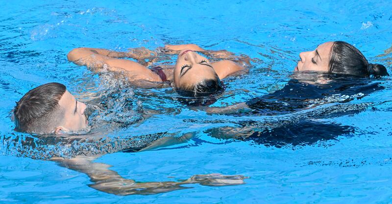 Anita Alvarez is helped from the pool after collapsing during the artistic swimming event at the World Aquatics Championships. AP