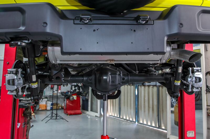 A Jeep's shock absorber and coil-spring set-up before an upgrade
