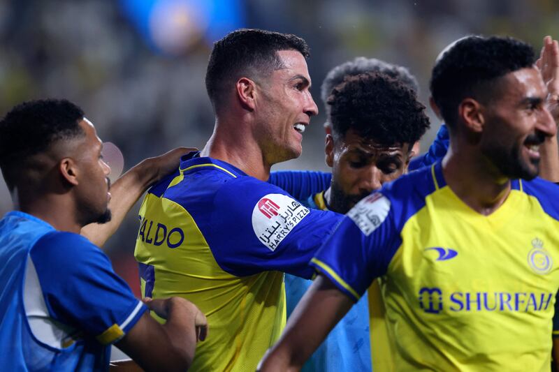 Al Nassr's Portuguese forward Cristiano Ronaldo celebrates with his teammates after scoring. AFP