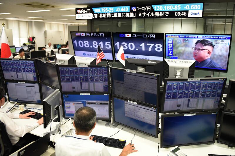 A television screen, top right, displays file news footage of North Korean leader Kim Jong-Un, at a foreign exchange brokerage in Tokyo on August 29, 2017, after a missile was launched by North Korea earlier in the day. Kazuhiro Nogi / AFP