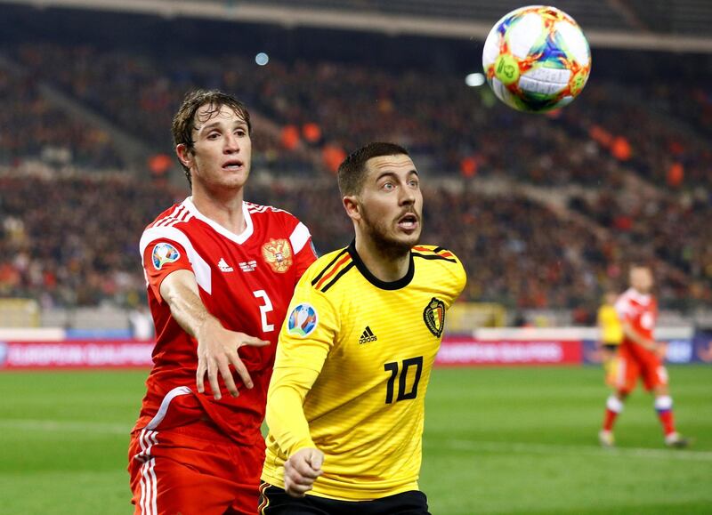 Hazard in action with Russia's Mario Fernandes. Reuters