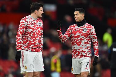Manchester United's Cristiano Ronaldo (R) and Harry Maguire (L) react during the warm up for the English Premier League soccer match between Manchester United and West Ham United in Manchester, Britain, 22 January 2022.   EPA/Peter Powell EDITORIAL USE ONLY.  No use with unauthorized audio, video, data, fixture lists, club/league logos or 'live' services.  Online in-match use limited to 120 images, no video emulation.  No use in betting, games or single club / league / player publications