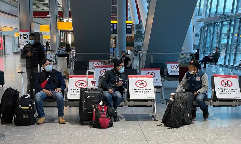 Travellers wait for their Covid-19 test results at Heathrow Airport in London. AP Photo