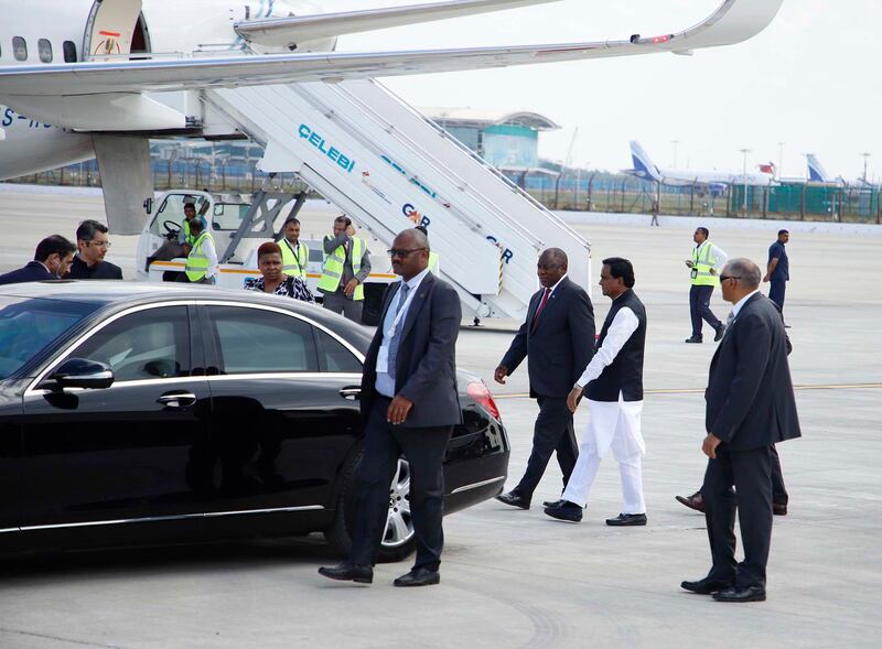 South African President Cyril Ramaphosa walks alongside India's Minister of State for Railways, Coal and Mines Raosaheb Danve, on his arrival for the G20 summit. EPA
