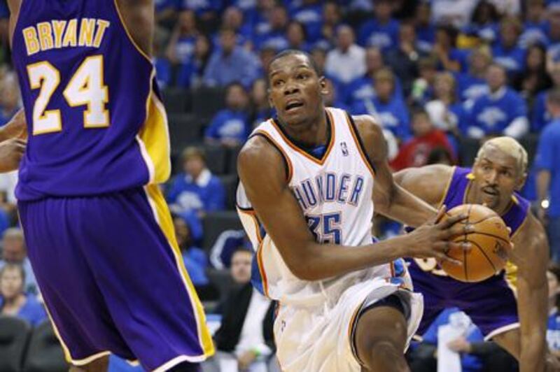 Thunder guard Kevin Durant drives against Kobe Bryant and Ron Artest of the Lakers.