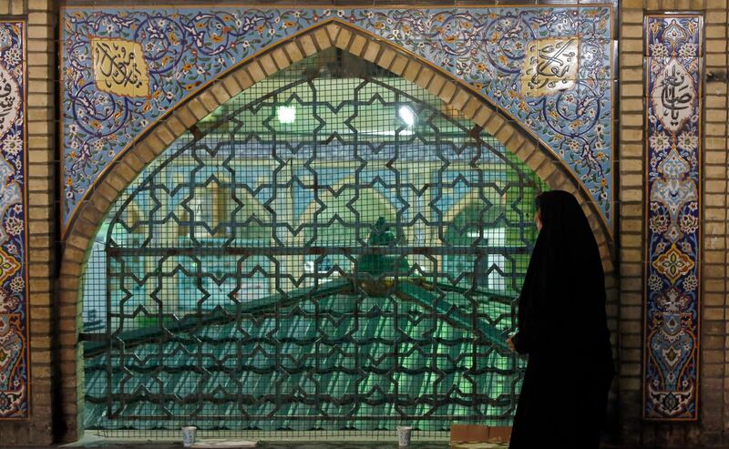 An Iranian woman prays outside of the Saleh Shrine on the eve of the holy month of Ramadan, in Tehran, Iran, 24 April 2020. EPA