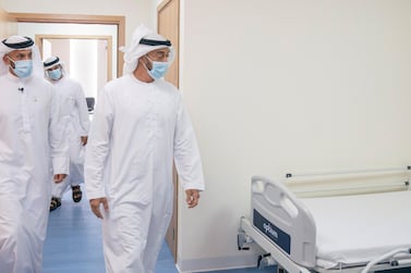 ABU DHABI, UNITED ARAB EMIRATES - May 18, 2020: HH Sheikh Mohamed bin Zayed Al Nahyan, Crown Prince of Abu Dhabi and Deputy Supreme Commander of the UAE Armed Forces (R) visits Emirates Field Hospital, at Emirates Humanitarian City. Seen with HE Sheikh Abdullah bin Mohammed Al Hamed, Chairman of the Department of Health - Abu Dhabi (L). ( Hamad Al Mansoori for the Ministry of Presidential Affairs )​ ---