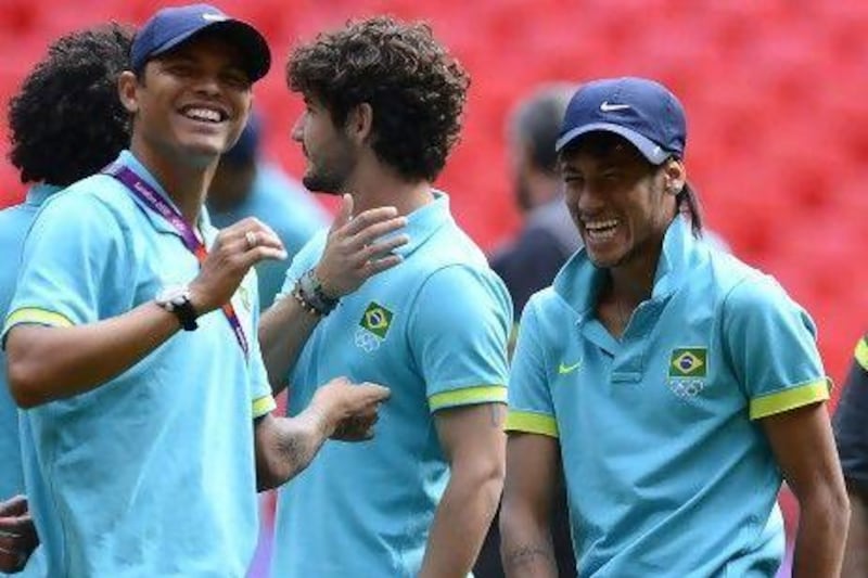 Brazil’s Neymar, right, and Thiago Silva, left, share a light moment ahead of the title clash at Wembley in London.