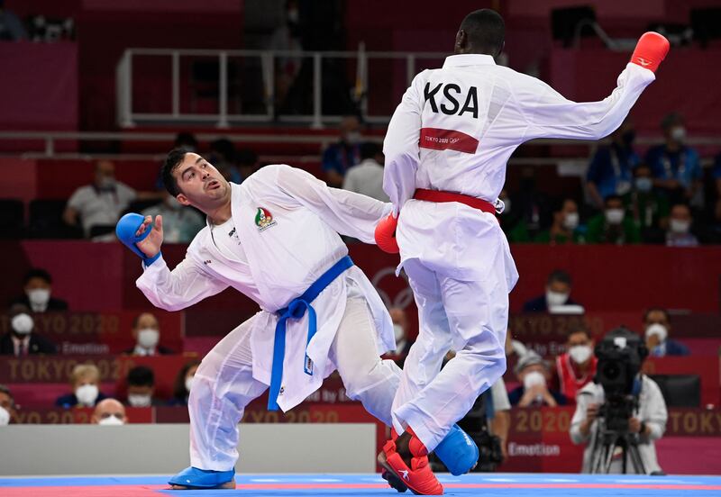 Saudi Arabia's Tareg Hamedi (R) competes against Iran's Sajad Ganjzadeh in the men's kumite +75kg final of the karate competition. Ganjzadeh was awarded the gold medal after Hamedi was disqualified in the final.