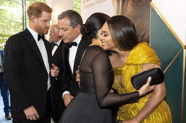 Britain's Prince Harry, Duke of Sussex (L) chats with Disney CEO Robert Iger as Britain's Meghan, Duchess of Sussex (2nd R) embraces US singer-songwriter Beyoncé (R) as they attend the European premiere of the film The Lion King in London on July 14, 2019. / AFP / POOL / Niklas HALLE'N