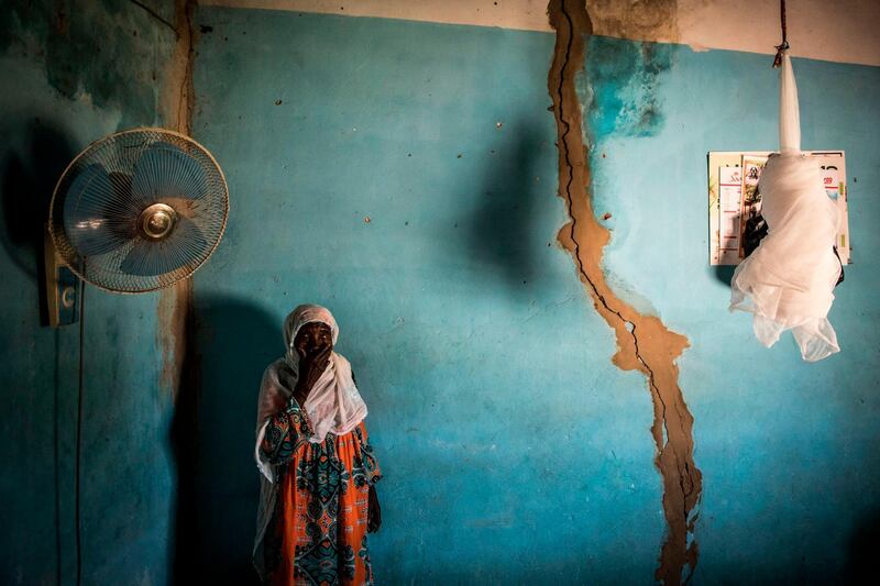 Khady is seen in her kitchen, next to a large crack that is cause by detonations from rock quarries that are moving closer to the village and threatening Bandia Forest, in the town of Bandia. The need for cement in a growing Dakar means that quarries are need to feed the factories, these quarries are moving closer to villages and threatening Bandia Forest.  AFP