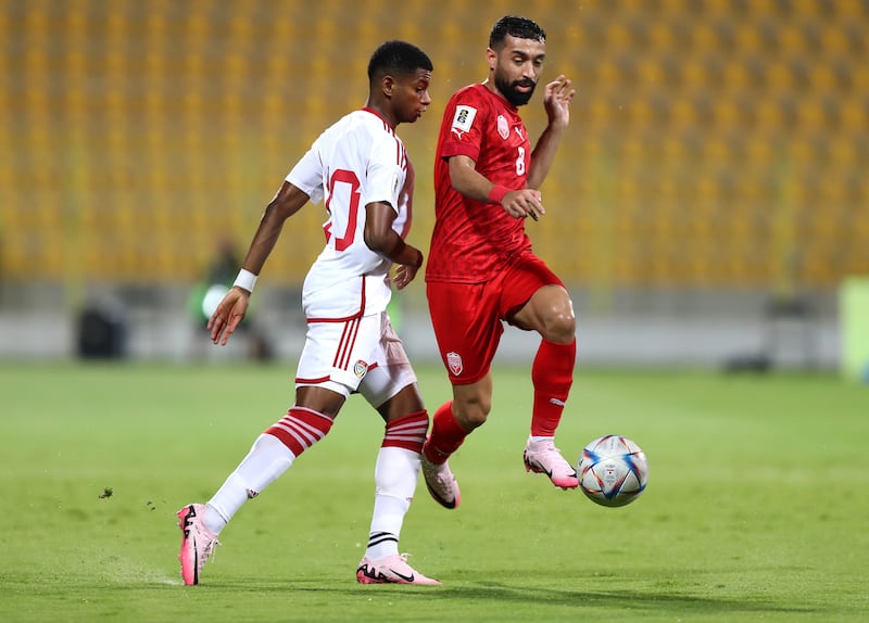 UAE's Yahya Al Ghassani and Bahrain's Mohamed Marhoon challenge for the ball during the match at Zabeel Stadium.