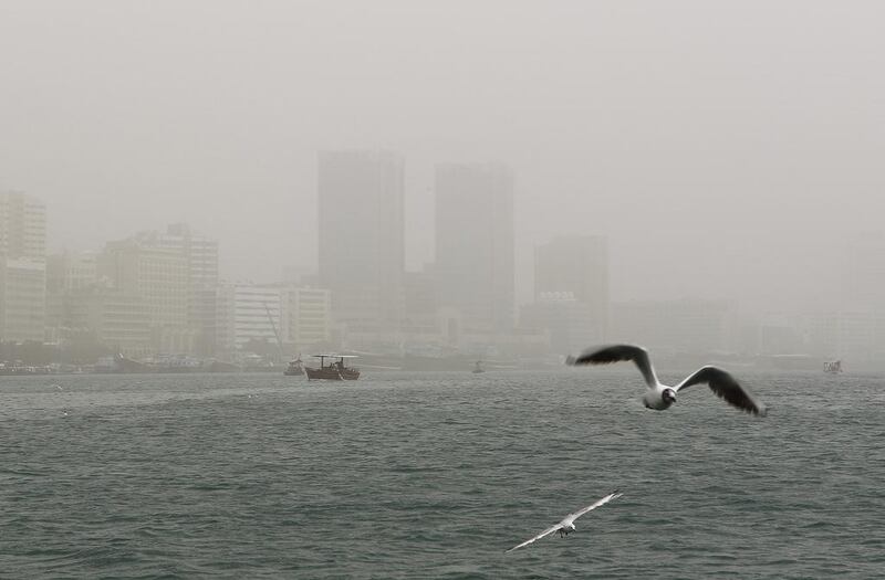 A sandstorm blows through Dubai lowering visibility around the creek. Jeffrey E Biteng / The National