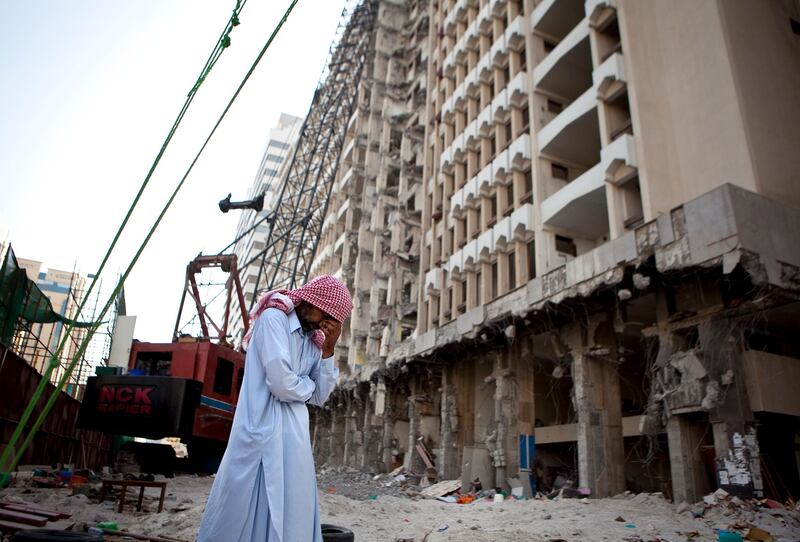 A demolition drill operator takes a break from work as the early-morning life slowly gets going on the Sheikh Zayed the First street in the Khalidiya neighborhood in Abu Dhabi on Tuesday, August 2, 2011, kthe second day of Ramadan. (Silvia Razgova/The National)

