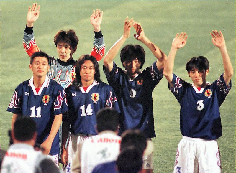 Japanese players wave to their suporters after winning their Asian Cup soccer match against the Syrian team 06 December at the Al-Ain stadium. Japan beat Syria 2-1. (Photo by JORGE FERRARI / AFP)