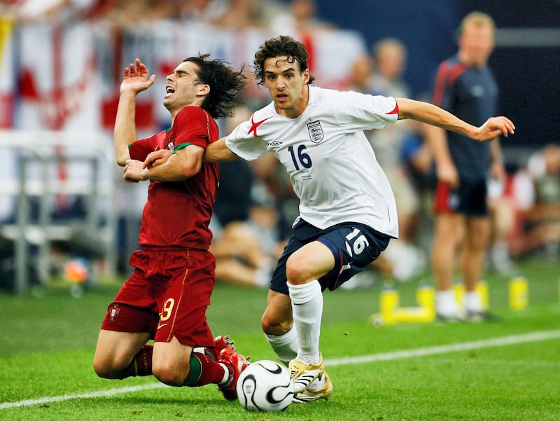 GELSENKIRCHEN, GERMANY - JULY 01: Tiago of Portugal falls to the ground as Owen Hargreaves of England surges forward during the FIFA World Cup Germany 2006 Quarter-final match between England and Portugal played at the Stadium Gelsenkirchen on July 1, 2006 in Gelsenkirchen, Germany. (Photo by Clive Mason/Getty Images)
