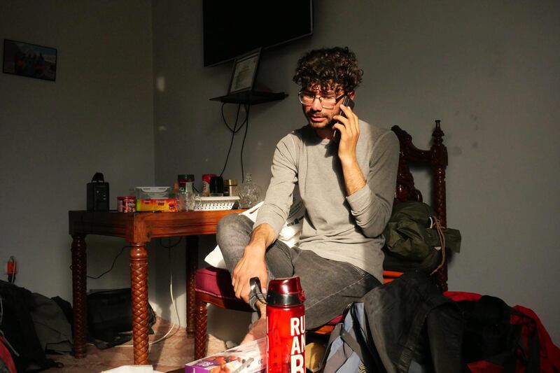 Pictured: Zabih Afzali sits in his friends' office in Kabul making phone calls to get everything organised ahead of a trip to Bamyan for a mountain expedition over the Eid holiday. 
Photo by Charlie Faulkner
May 2021