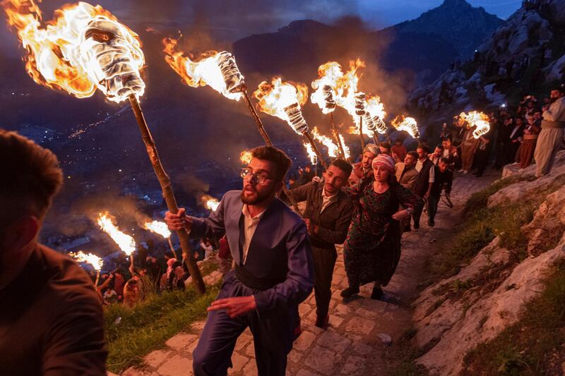 Iraqi Kurds carry torches up Kali mountain to celebrate Nowruz, the Persian New Year, in Akre, Iraq. Getty Images