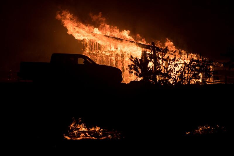 Flames consume a structure as a wildfire burns in Casitas Springs, California. Noah Berger / AP Photo