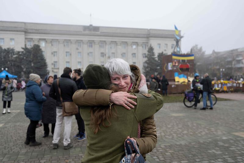 A woman embraces her friend, a soldier in the Ukrainian army, in Kherson. AFP