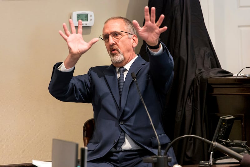 Tim Palmbach, a forensic scientist, demonstrates the effect of a shotgun blast during the double-murder trial. AP