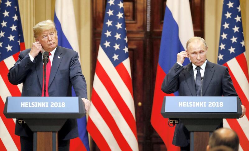 epa08939637 (FILE) US President Donald J. Trump (L) and Russian President Vladimir Putin (R) adjust their earpiece plugs during a joint press conference following their summit talks at the Presidential Palace in Helsinki, Finland, 16 July 2018. The presidency of Donald Trump, which records two presidential impeachments, will end at noon on 20 January 2021.  EPA-EFE/ANATOLY MALTSEV *** Local Caption *** 56621650