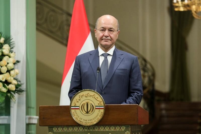 In this photo released by official website of the office of the Iranian Presidency, Iraqi President Barham Salih attends a joint press briefing with his Iranian counterpart Hassan Rouhani after their meeting at the Saadabad Palace in Tehran, Iran, Saturday, Nov. 17, 2018. Salih began a visit to Iran on Saturday, where he pledged to improve relations less than two weeks after the United States restored oil sanctions that had been lifted under the 2015 nuclear deal. (Iranian Presidency Office via AP)