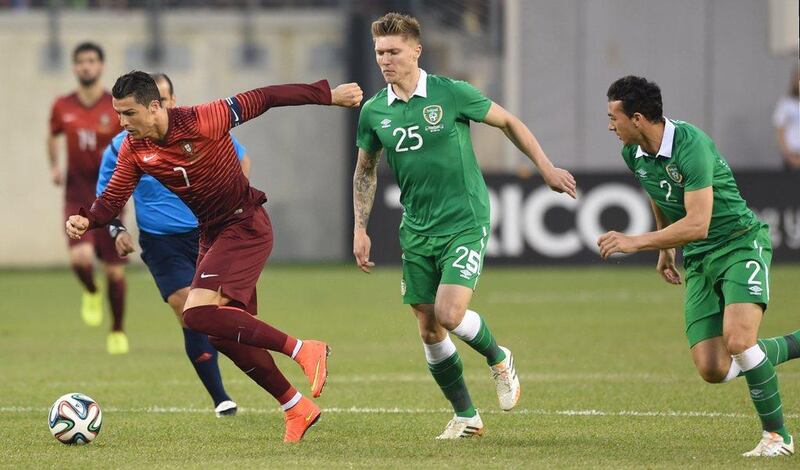 Cristiano Ronaldo of Portugal moves the ball against Jeff Hendrick, centre, and Stephen Kelly, right, of Ireland during their international friendly on Tuesday in New Jersey, USA. Stan Honda / AFP / June 10, 2014