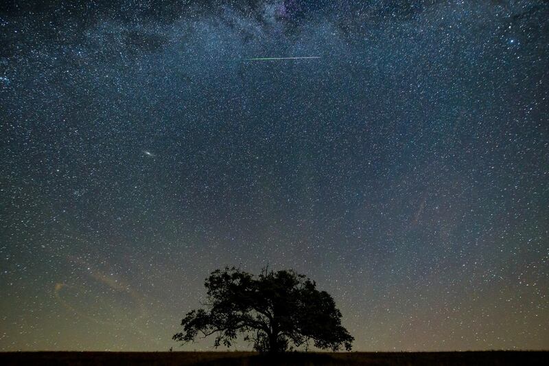 A meteor streaks through the sky during the Perseid meteor shower above the village of Hajnacka, Slovakia. EPA