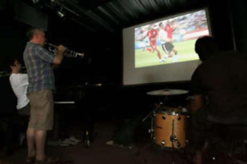 A jazz band improvises with a musical commentary to the England versus Germany World Cup game at a club in London.